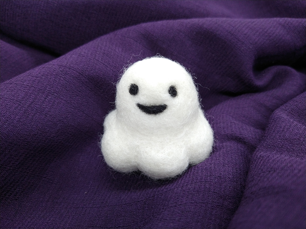 An adorably cute, chonky little needle felted ghost with a happy smile. His name is Sebastian.